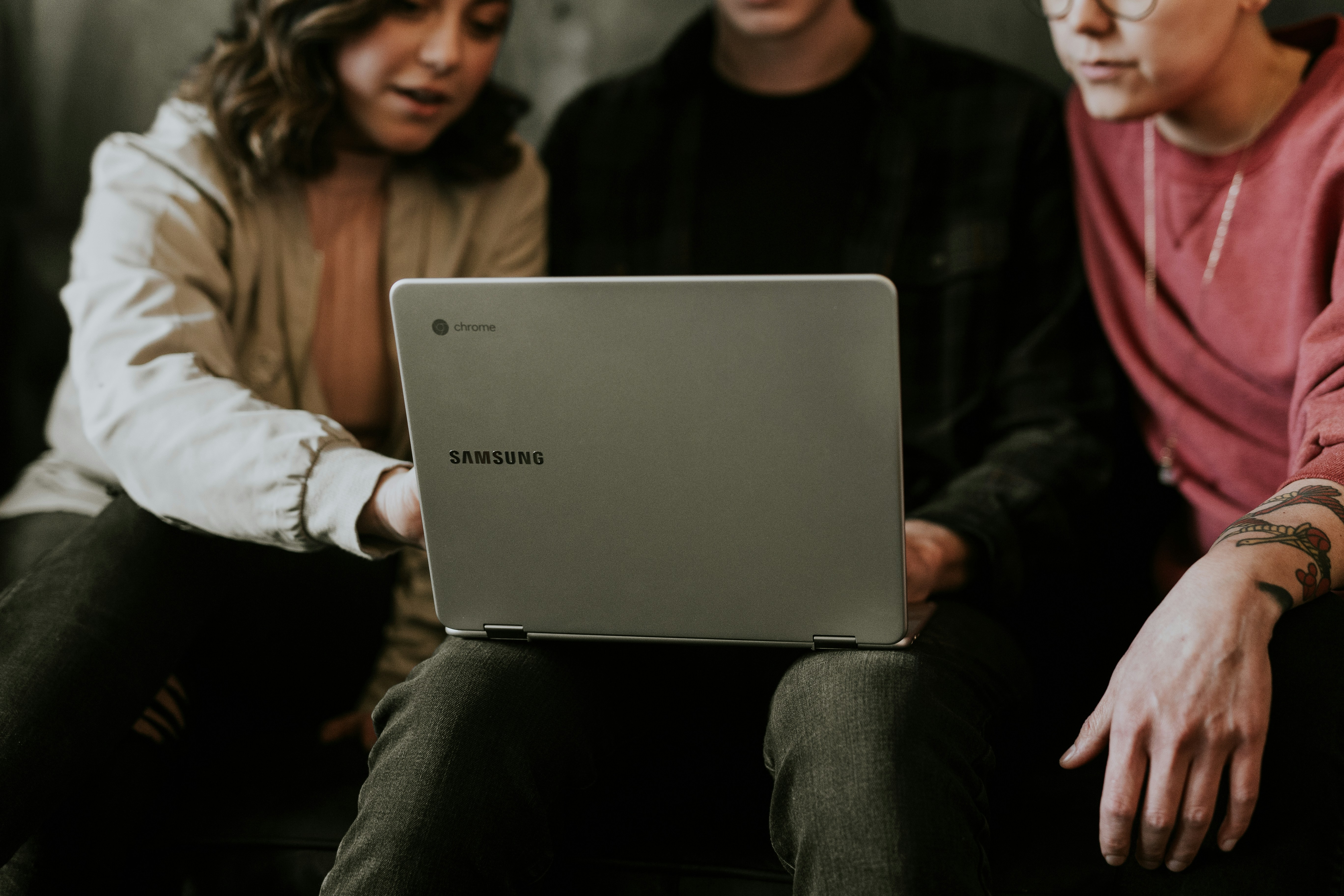Team collaborating around a laptop, representing strategic marketing consultation